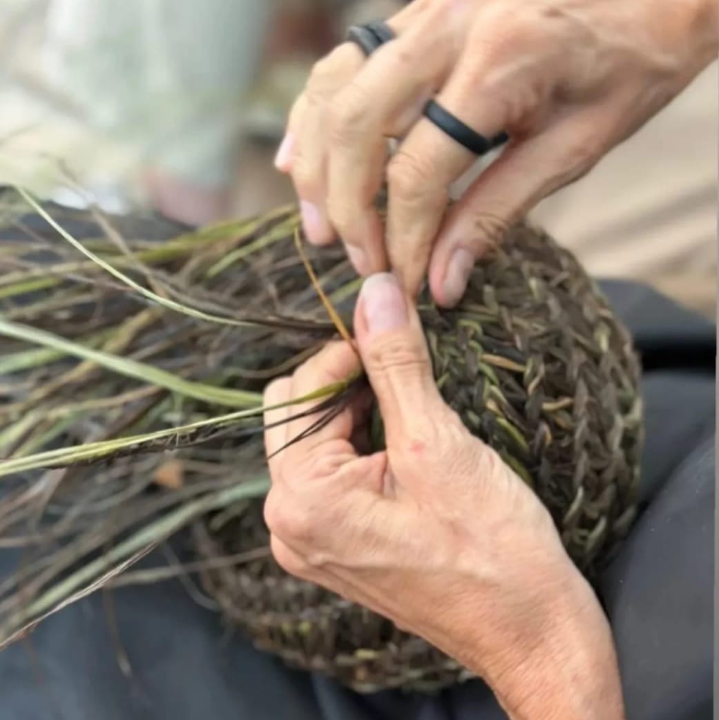 hands weaving a basket at weaving lagrasse organised by beverly smart